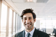 Successful young businessman standing in office Successful young businessman standing in office