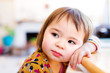 Toddler girl leaning against table Toddler girl leaning against table