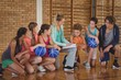 Female coach mentoring high school kids Female coach mentoring high school kids