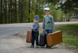 Two boys go on the road with big suitcases Two boys go on the road with big suitcases