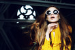 Close up indoor portrait of young beautiful fashionable woman with long hair. wearing stylish round sunglasses, yellow blouse. Model looking up. Female fashion concept. Copy, empty space for text Close up indoor portrait of young beautiful fashionable woman with long hair. wearing stylish round sunglasses, yellow blouse. Model looking up. Female fashion concept. Copy, empty space for text