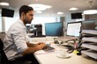 Focused businessman using desktop pc in office Focused businessman using desktop pc in office