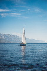 Sailing yacht in the sea against the backdrop of mountains