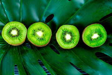 kiwi for healthy fruit dessert on green tropical background top view