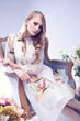 Fashion portrait of young blond woman with flowers. Fashion portrait of young blond woman with flowers.