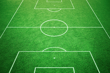 Soccer playfield ground lines on sunny grass background. Goal side perspective used.