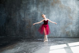 girl ballerina in red tutu doing exercise