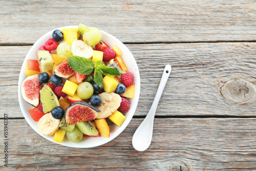 Fresh fruit salad on a grey wooden table
