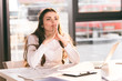 pensive businesswoman sitting at workplace with laptop in modern office pensive businesswoman sitting at workplace with laptop in modern office