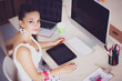Young woman working in office, sitting at desk Young woman working in office, sitting at desk