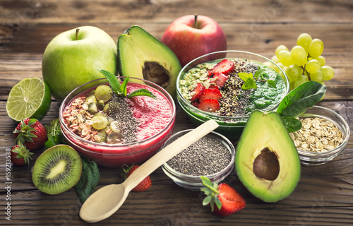 Smoothies in the bowl with fruits and seeds 