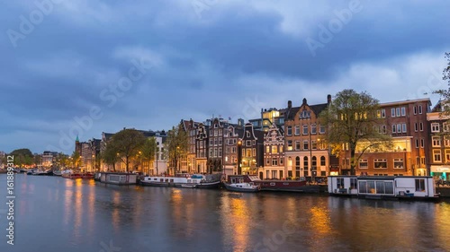 Amsterdam city skyline day to night timelapse at canal waterfront, Amsterdam, Netherlands, 4K Time Lapse