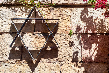 Star of David on the stone wall background