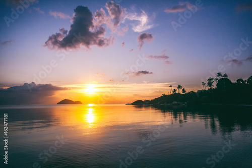 Magnificent beautiful bright tropical sunset, sun, palms, sandy beach
