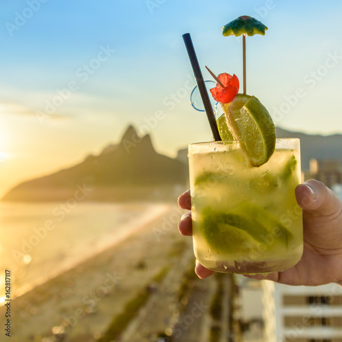 Kiwi caipirinha cocktail overlooking Rio de Janeiro, Brazil Kiwi caipirinha cocktail overlooking Rio de Janeiro, Brazil