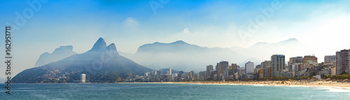 Panoramic landscape of the beaches of Arpoador, Ipanema and Leblon in Rio de Janeiro with sky and the hill Two brothers, Vidigal, and Gávea stone in the background Panoramic landscape of the beaches of Arpoador, Ipanema and Leblon in Rio de Janeiro with sky and the hill Two brothers, Vidigal, and Gávea stone in the background