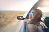 Trendy girl traveling by car