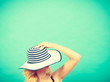 Woman hiding face behind sun hat Woman hiding face behind sun hat