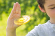 The boy holds a yellow fidget hand spinner The boy holds a yellow fidget hand spinner