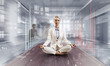 Business lady meditating at work. Mixed media Business lady meditating at work. Mixed media