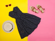 Fashionable concept. Female summer wardrobe. Straw hat, sundress, sunglasses, sandals. Yellow background, top view Fashionable concept. Female summer wardrobe. Straw hat, sundress, sunglasses, sandals. Yellow background, top view