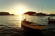 Small boats, fishing trawler and a sailboat moored in the harbor of a town Postira - Croatia, island Brac Small boats, fishing trawler and a sailboat moored in the harbor of a town Postira - Croatia, island Brac