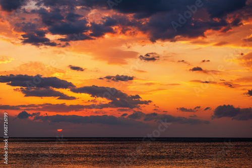 Beautiful sunrise over the sea with scenic clouds