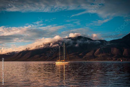 Landscape of a nature of a pink sunset with clouds in the mountains of Spitsbergen Svalbard near the Norwegian city Longyearbyen