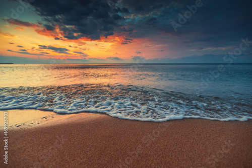 Beautiful sunrise over the sea water and waves