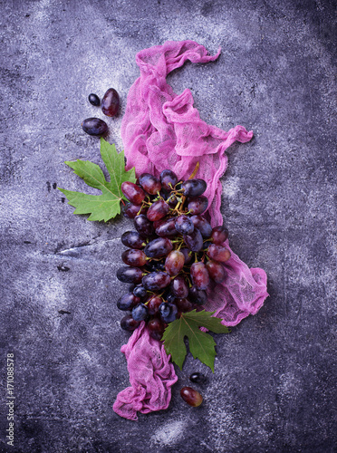 Bunch of purple grapes on concrete background