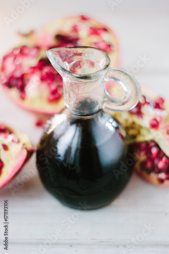 Glass jar with the pomegranate sauce inside it.