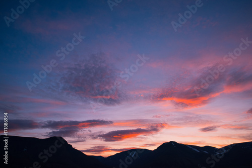 Landscape travel of a nature of a sunset sunrise with clouds in the mountains of Spitsbergen Svalbard near the Norwegian city Longyearbyen