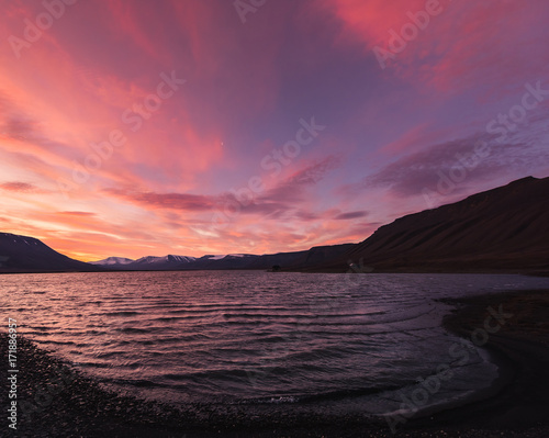 Landscape travel of a nature of a sunset sunrise with clouds in the mountains of Spitsbergen Svalbard near the Norwegian city Longyearbyen