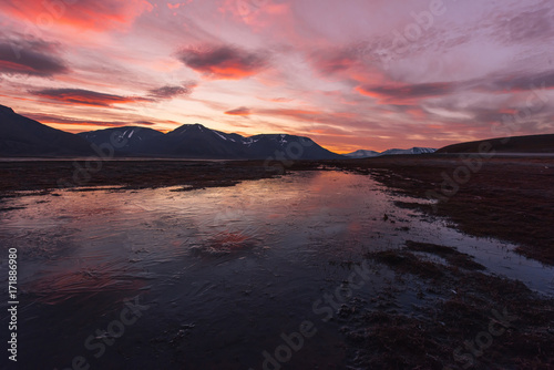 Landscape travel of a nature of a sunset sunrise with clouds in the mountains of Spitsbergen Svalbard near the Norwegian city Longyearbyen