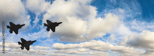 Fotoobraz na płótnie Sylwetki trzech samolotów F-35 przeciw błękitne niebo i białe chmury
