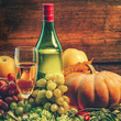 grape wine and bright pumpkins, grapes and apples on a wooden background. holiday halloween grape wine and bright pumpkins, grapes and apples on a wooden background. holiday halloween