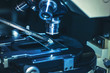 scientific microscope lens. observing a pipette with a suspension. dripping on a preparative glass scientific microscope lens. observing a pipette with a suspension. dripping on a preparative glass