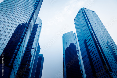 directly below of modern financial skyscrapers in central Hong Kong,blue toned,china.