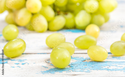 Grapes berries on the old blue wooden table. Close up.