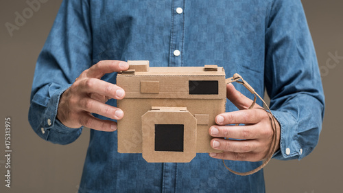 Photographer holding a cardboard camera