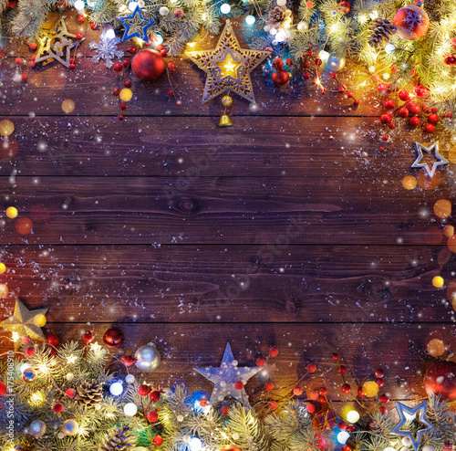 Christmas Background - Snowy Fir Branches And Lights On Dark Table
