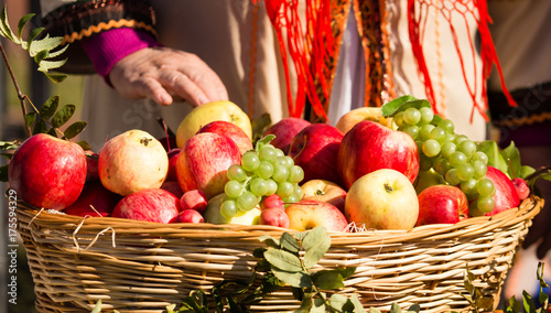 ripe apples with grapes in a basket