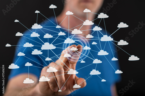 Man touching a cloud network on a touch screen