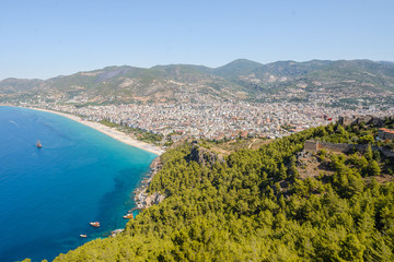 View from the mountain to the sea bay with blue water and to the city