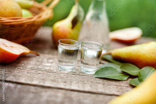 Shot glass with pear liqueur on table