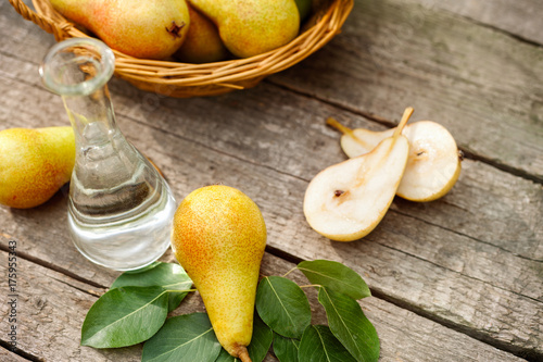 Pears on the table with glass bottle