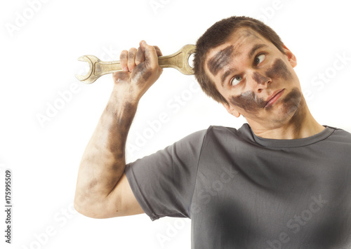 dirty and funny mechanic with wrench thinking isolated on white