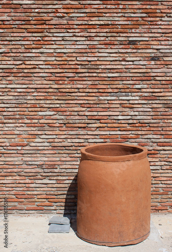 clay pot near old brik wall