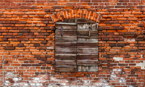 Old bricks wall texture with shutters.
