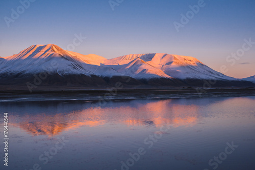 Landscape of a nature of a pink sunset in the reflection ocean mountains of Spitsbergen Svalbard near the Norwegian city Longyearbyen